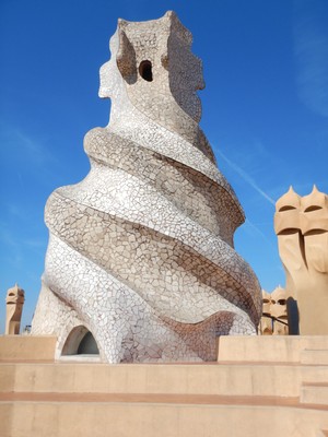 This is not a chimney but, rather, a disguised stairwell opening onto the roof; there are chimneys as well as ventilation towers as Gaudi worked to address three of his priorities: insulation, lighting and ventilation