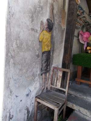 Boy on chair by Ernest Zacharevic, Georgetown, Penang, Malaysia.