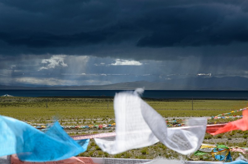Prayer flags in front of heavy clouds